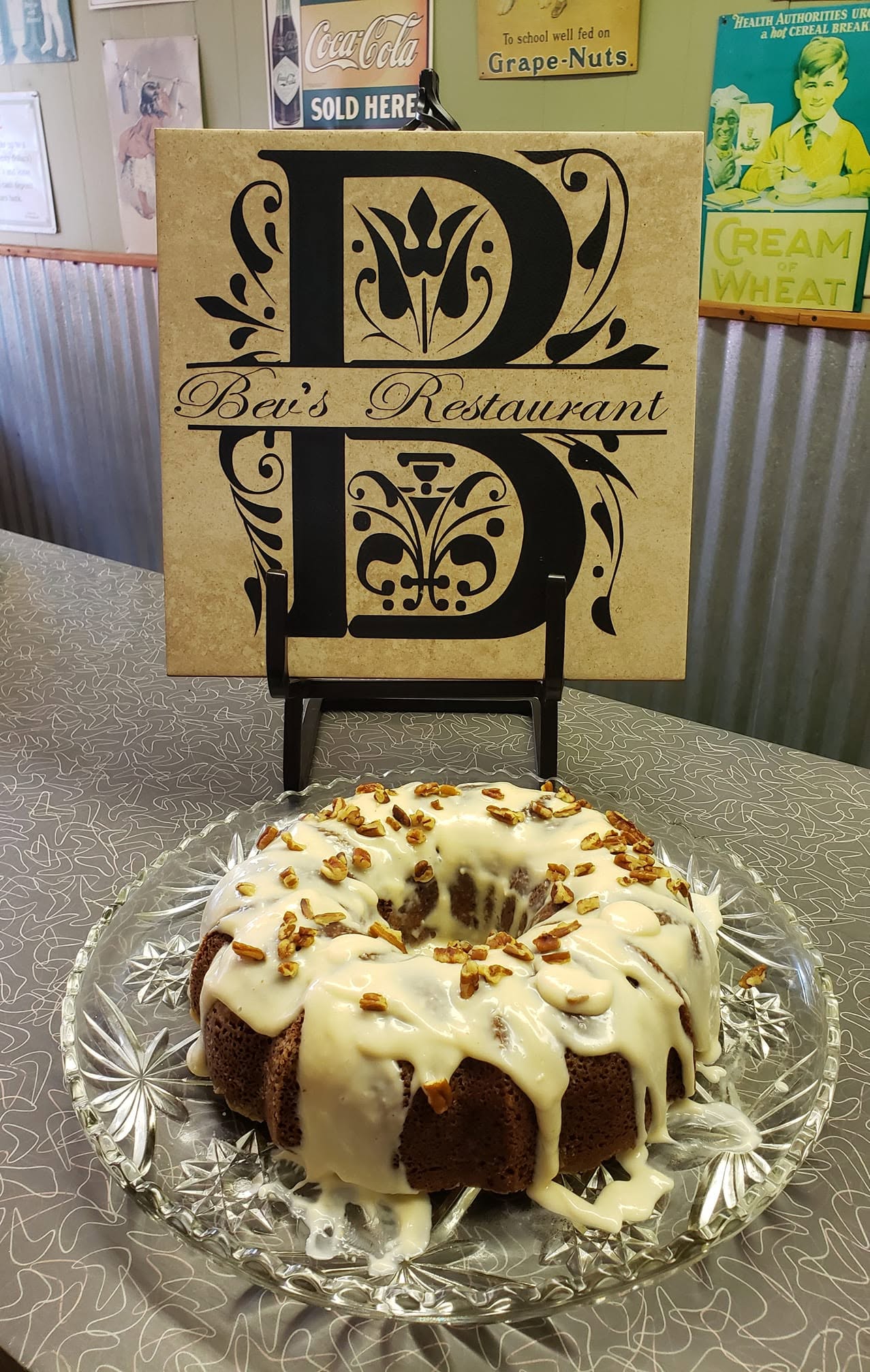 Chop suey cake with cream glaze beside the Bev's Restaurant sign
