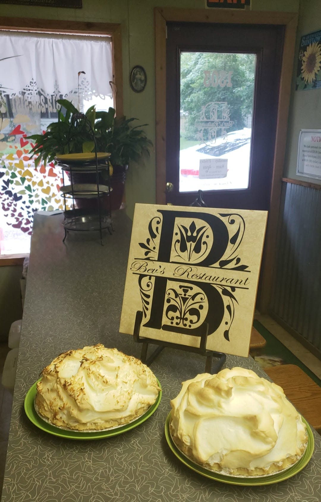 Two towering meringue pies next to the Bev's Restaurant sign